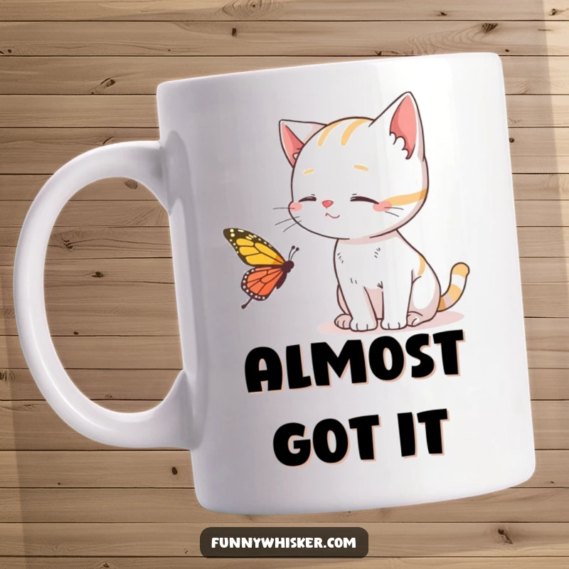 Funny Cat Mug depicting a cat trying to catch a butterfly with its whiskers, capturing a moment of playful pursuit, ideal gift.