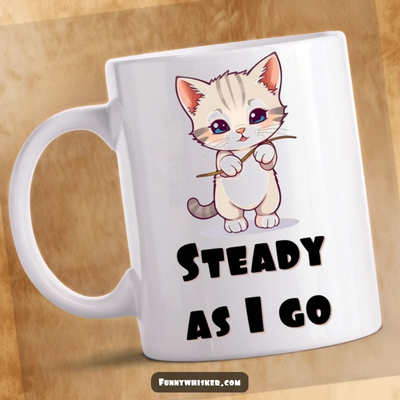 Funny kitten precariously balancing on a very wobbly whisker, depicted on a mug, ideal funny gift.