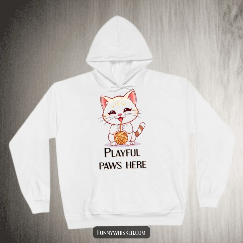 Funny hoodie depicting a kitten with large whiskers joyfully interacting with a yarn ball, ideal for cozy comfort.