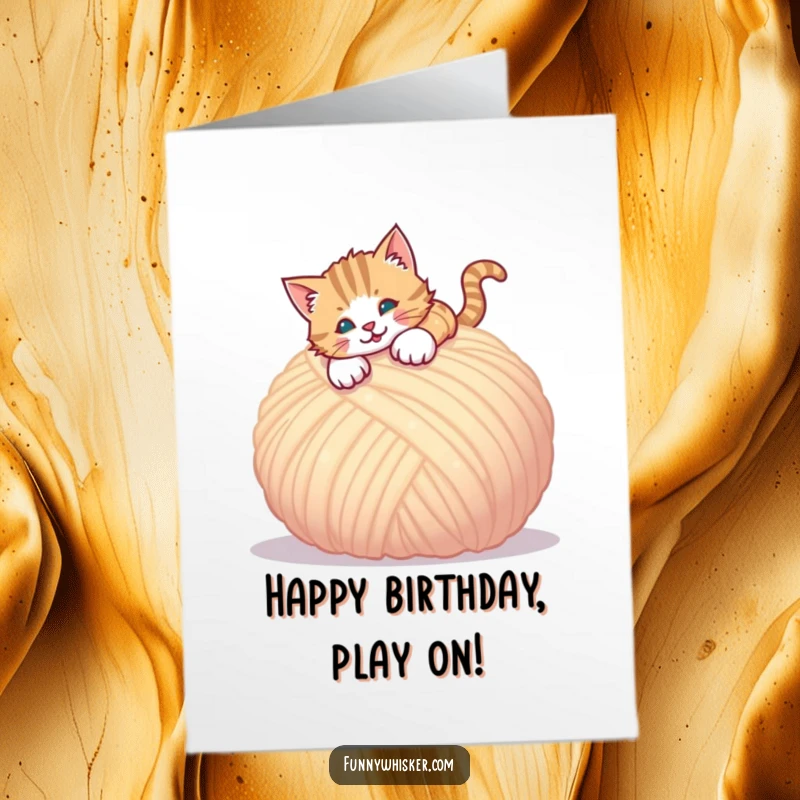 Funny Free Printable Birthday Card: A cat joyfully pouncing with all paws onto a comically large, fluffy ball of yarn. Playful chaos.