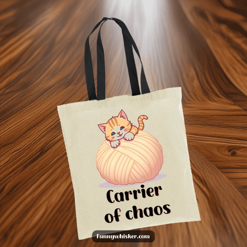 Funny tote bag showcasing a cat pouncing with excitement onto a giant ball of soft yarn.